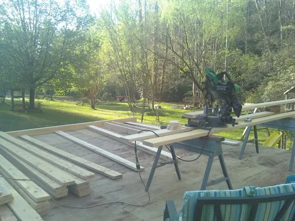 Miter saw and framing lumber on a deck under construction in Jacksonville